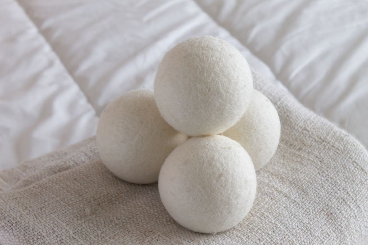 Three white dryer ball, showcasing their texture and color for the home made dryer. 